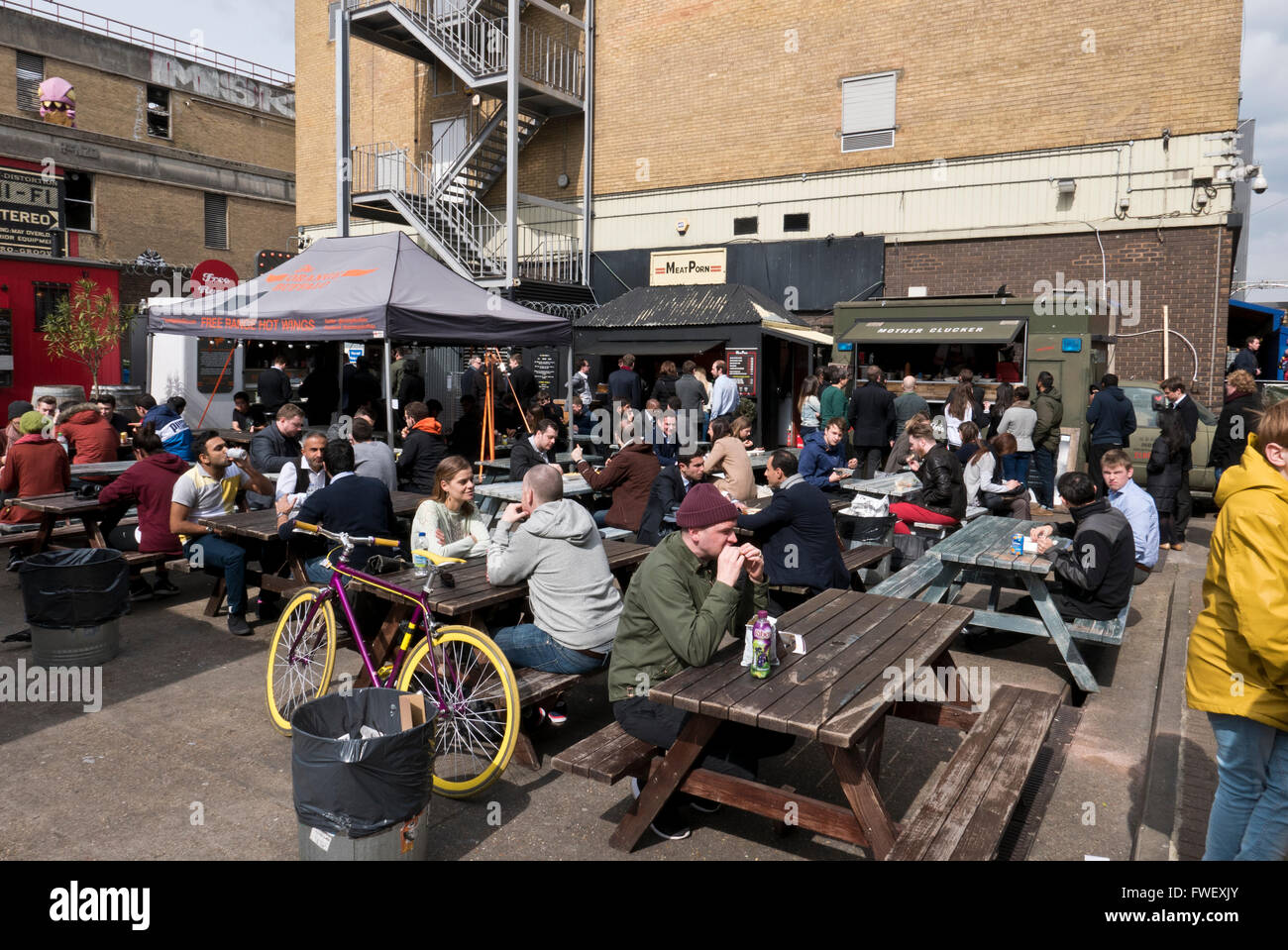 People eating fast food and drinking in an outdoor restaurant in London, United Kingdom. Stock Photo