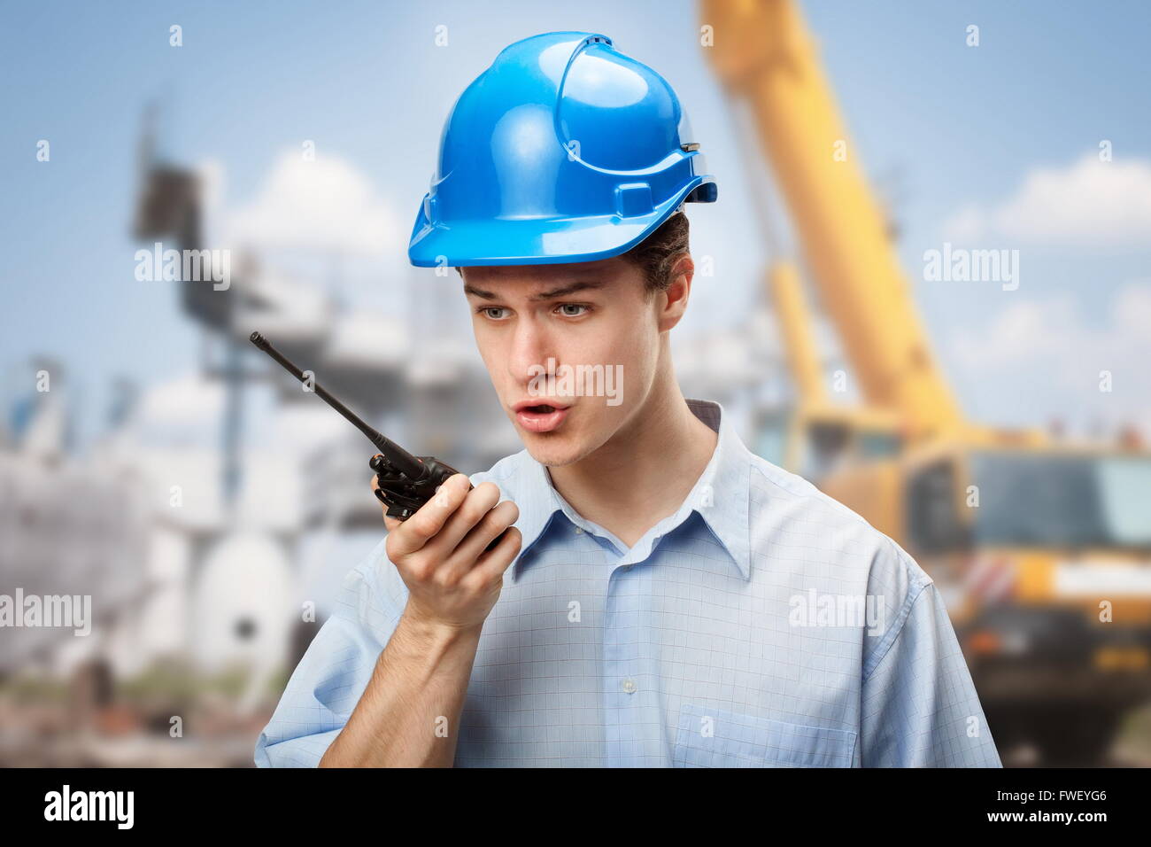 Young student learning to communicate and make decisions on construction site Stock Photo