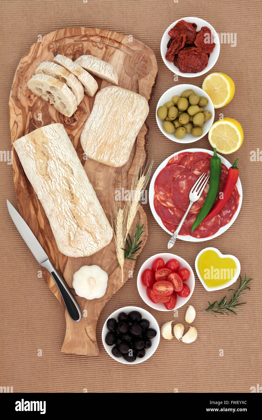 Italian antipasti selection with olives, salami, chili peppers, sun