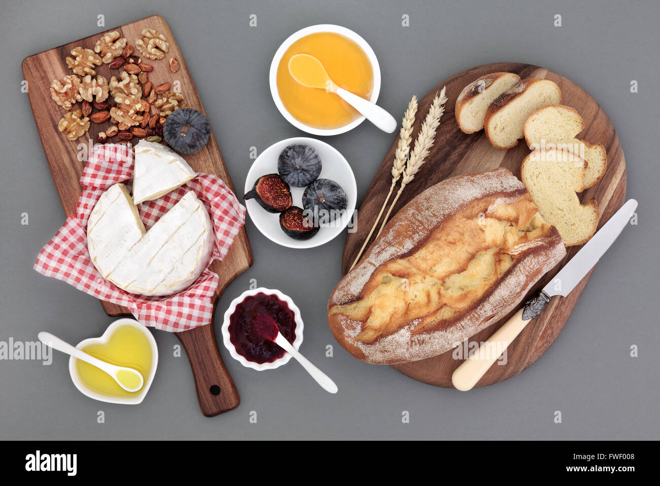 Rustic french snack food with camembert cheese, figs, red currant jam, honey, olive oil