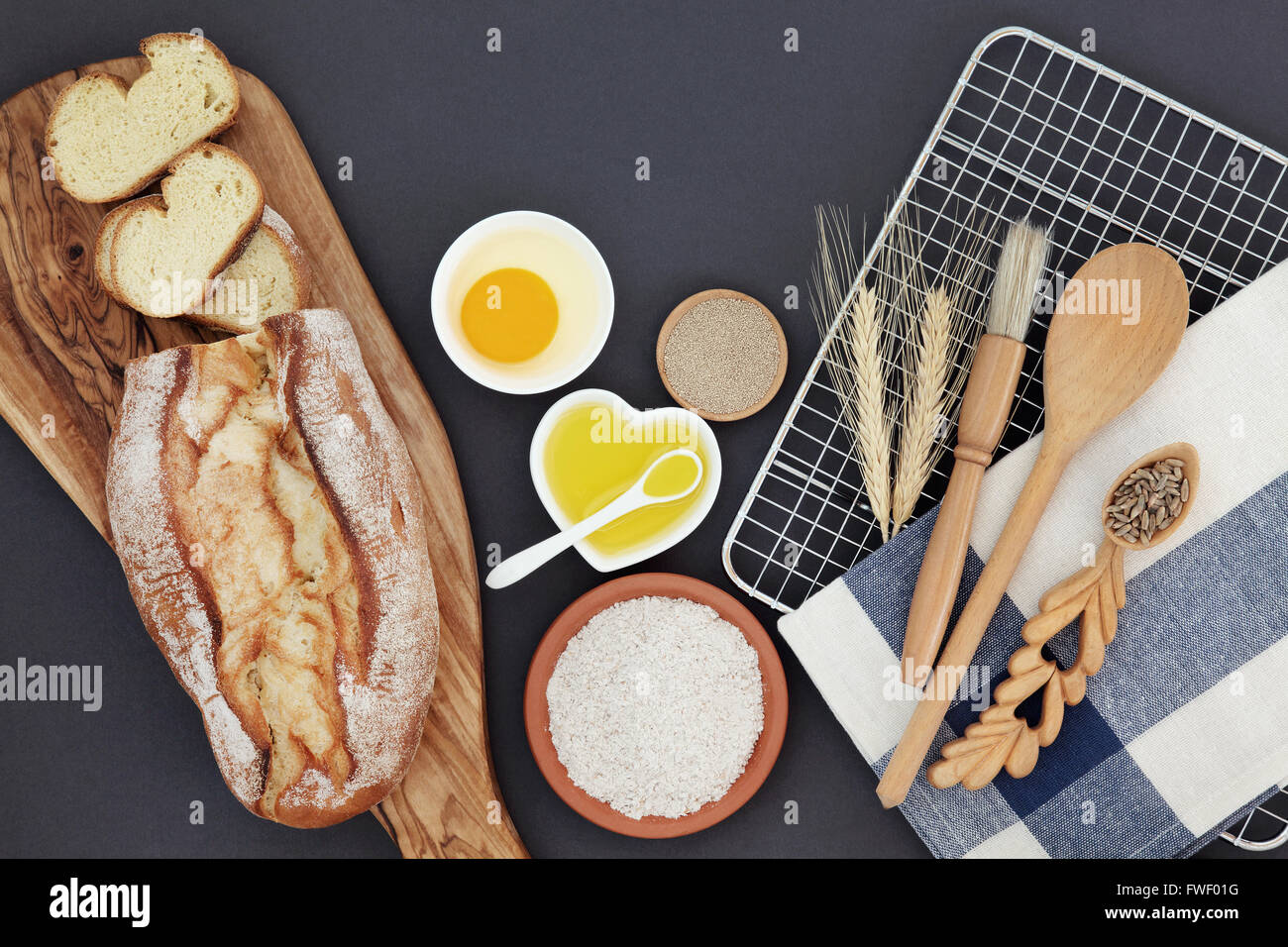French bread loaf with baking ingredients and utensils with wheat ...