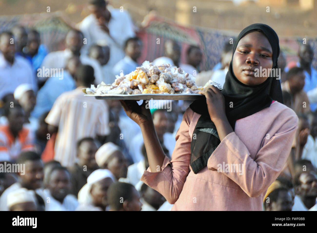 Nuba wrestling, Women carrying sweets Stock Photo