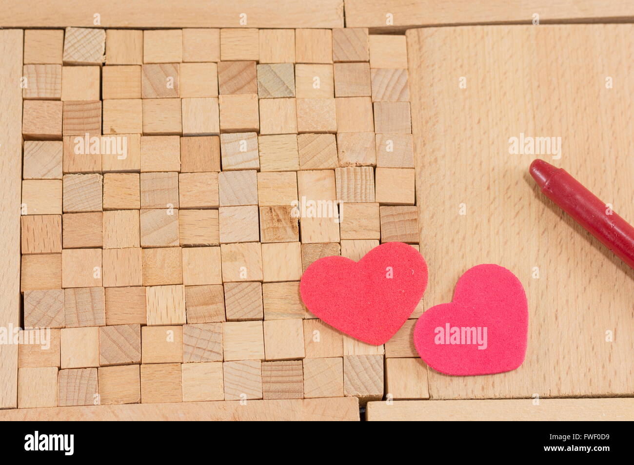 brown wooden blocks with hearts arranged on the blocks Stock Photo