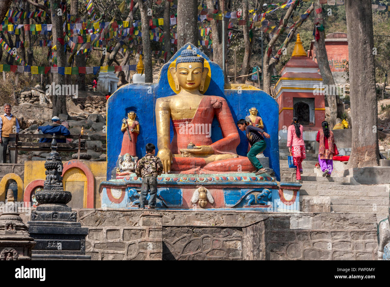 Nepal, Kathmandu, Swayambhunath. Buddha Statues Flank the Stairs