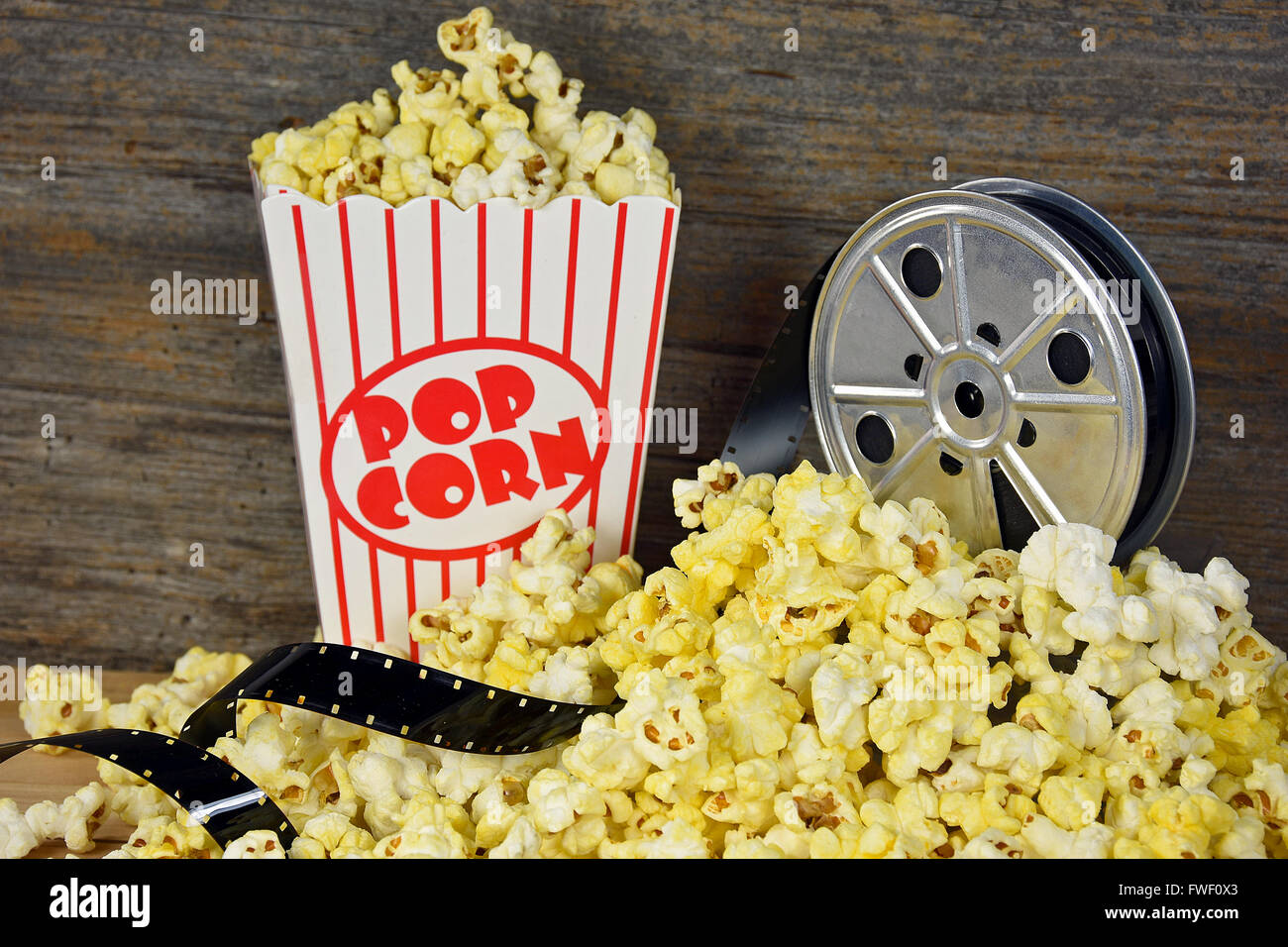 Old movie reel and film with popcorn. Stock Photo