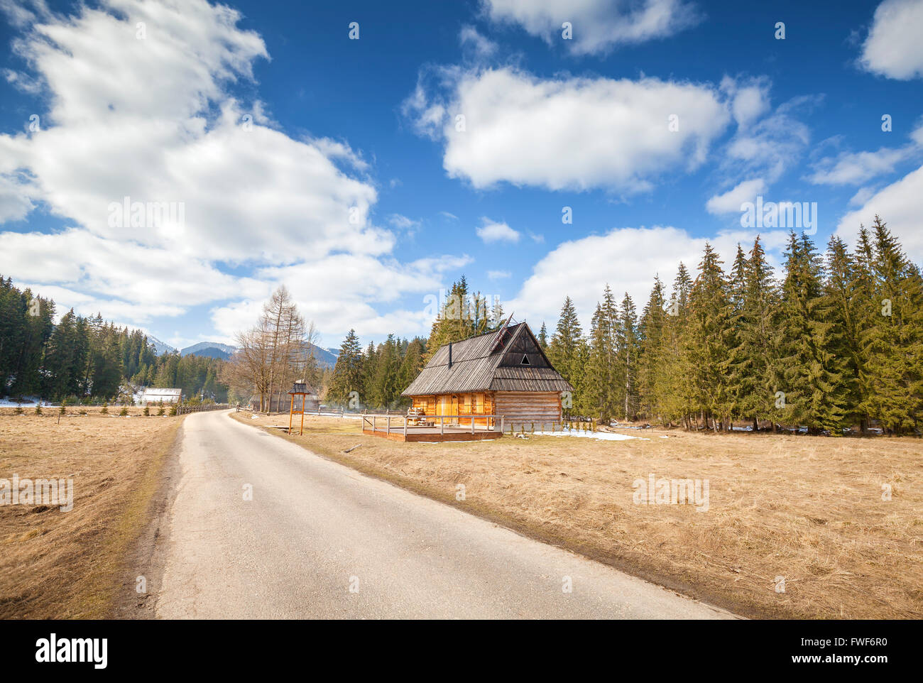 Wooden hut by a country road in Tatra Mountains, way to the Lake Morskie Oko, Poland. Stock Photo