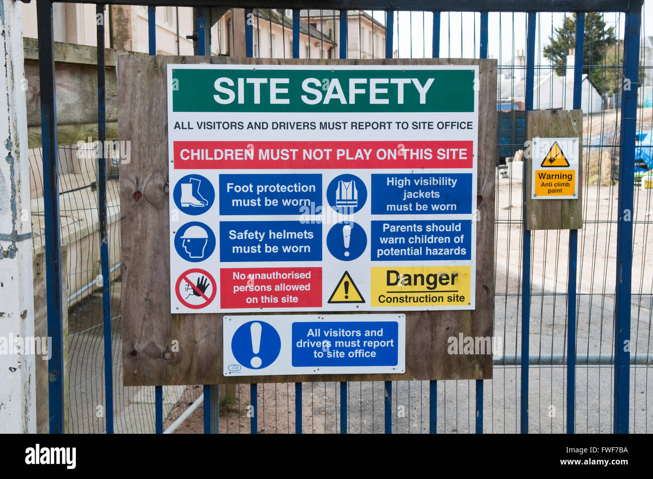 Sign on a building site displaying a variety of warnings and health and safety requirements Stock Photo
