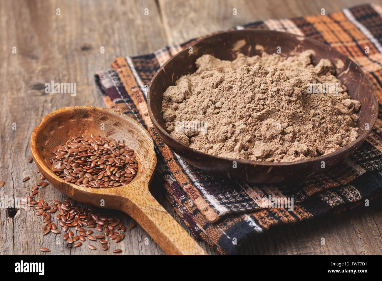 flax flour in a bowl, flax seeds  on a wooden background ( gluten-free diet ) Stock Photo
