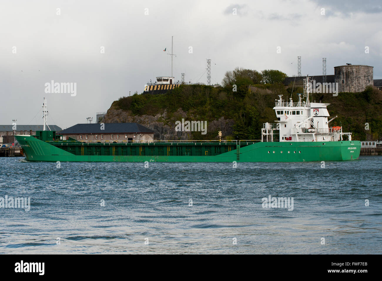 General Cargo Vessel 'Arklow Rebel' sails outbound past Haulbowline Naval Base, Cobh, Port of Cork, Cork, Ireland. Stock Photo
