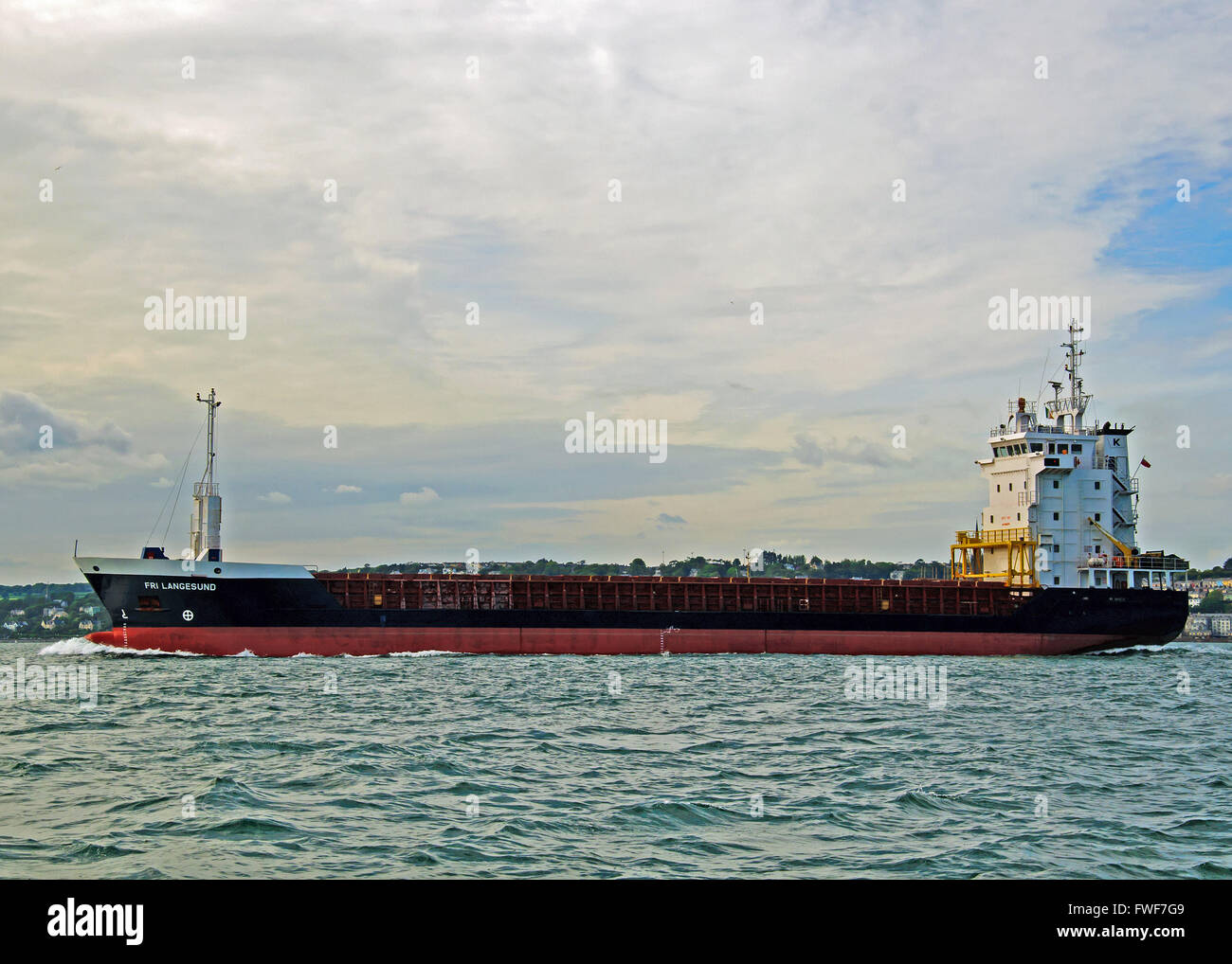 General cargo ship Fri Langesund sails through Cork Harbour, Ireland. Stock Photo