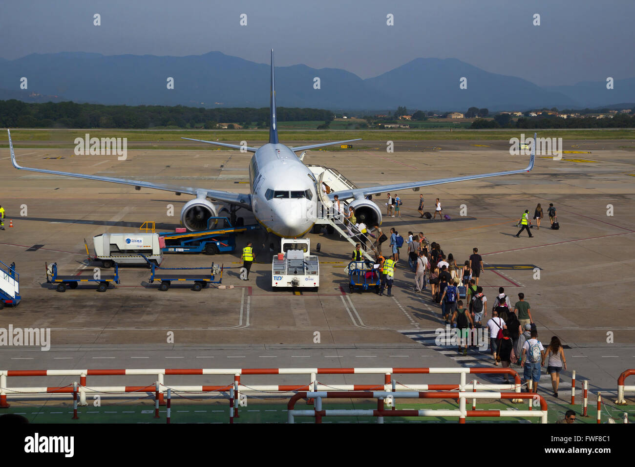 Tourists boarding in a low cost airplane at the terminal of the airport of Barcelona, S Stock Photo