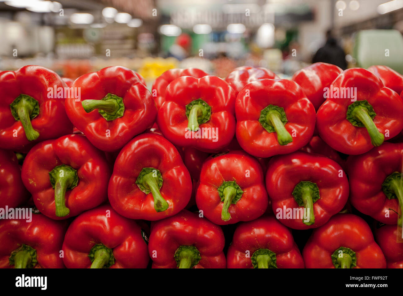 a display of red peppers at a Whole Foods Market in the produce section Stock Photo