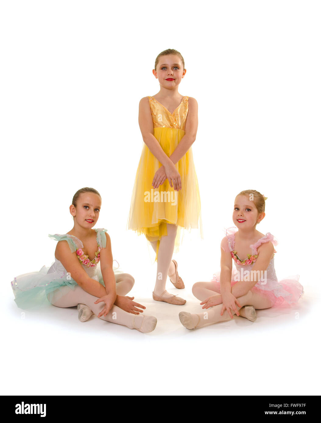 Three Girls Pose in their Ballet Dance Recital Costume Stock Photo