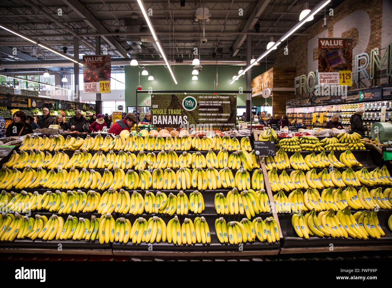 a display of banana bunches in the produce section of a grocery store