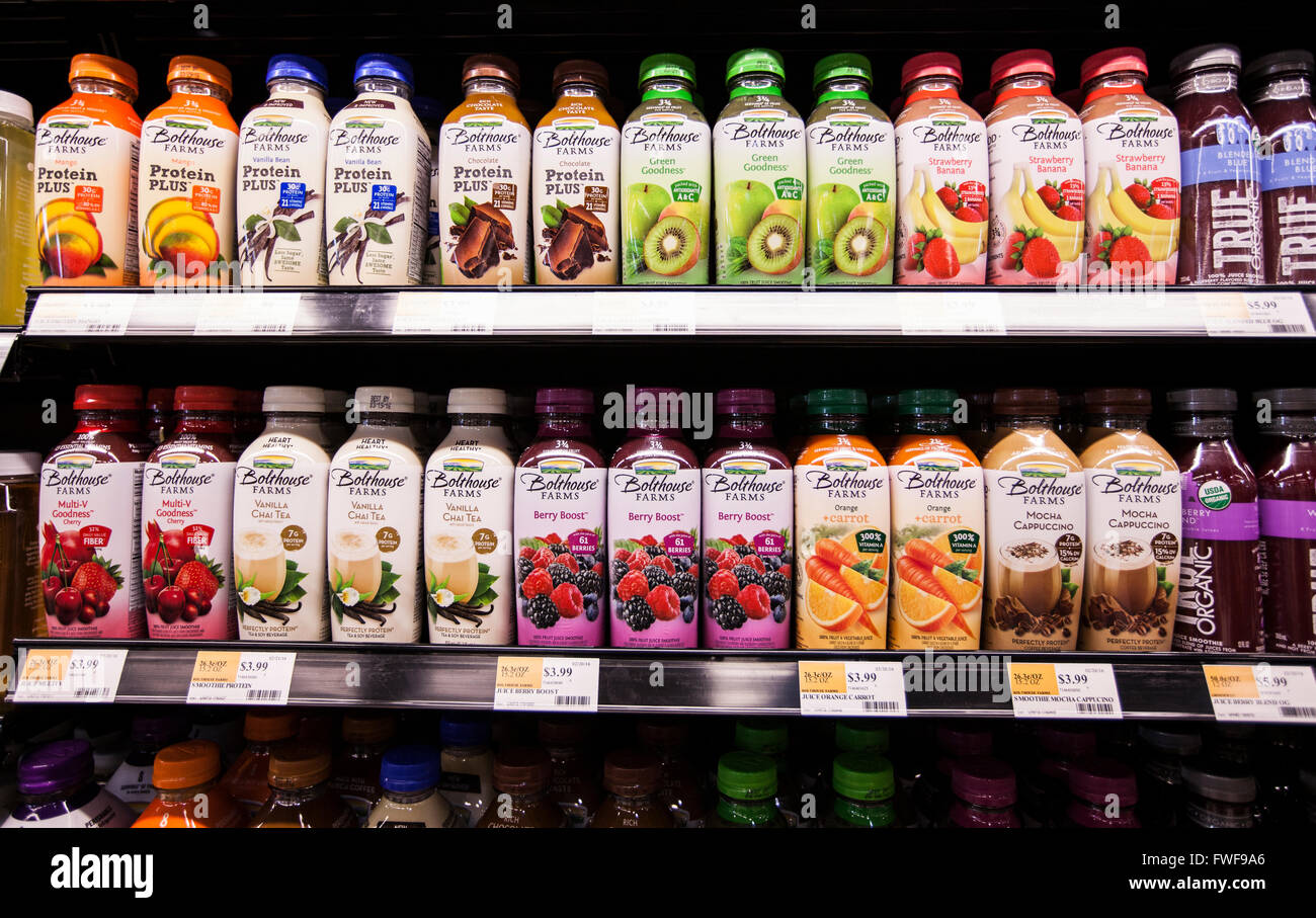 Shelves of Bolthouse Farms brand bottled smoothies in a refrigerator case in a grocery store