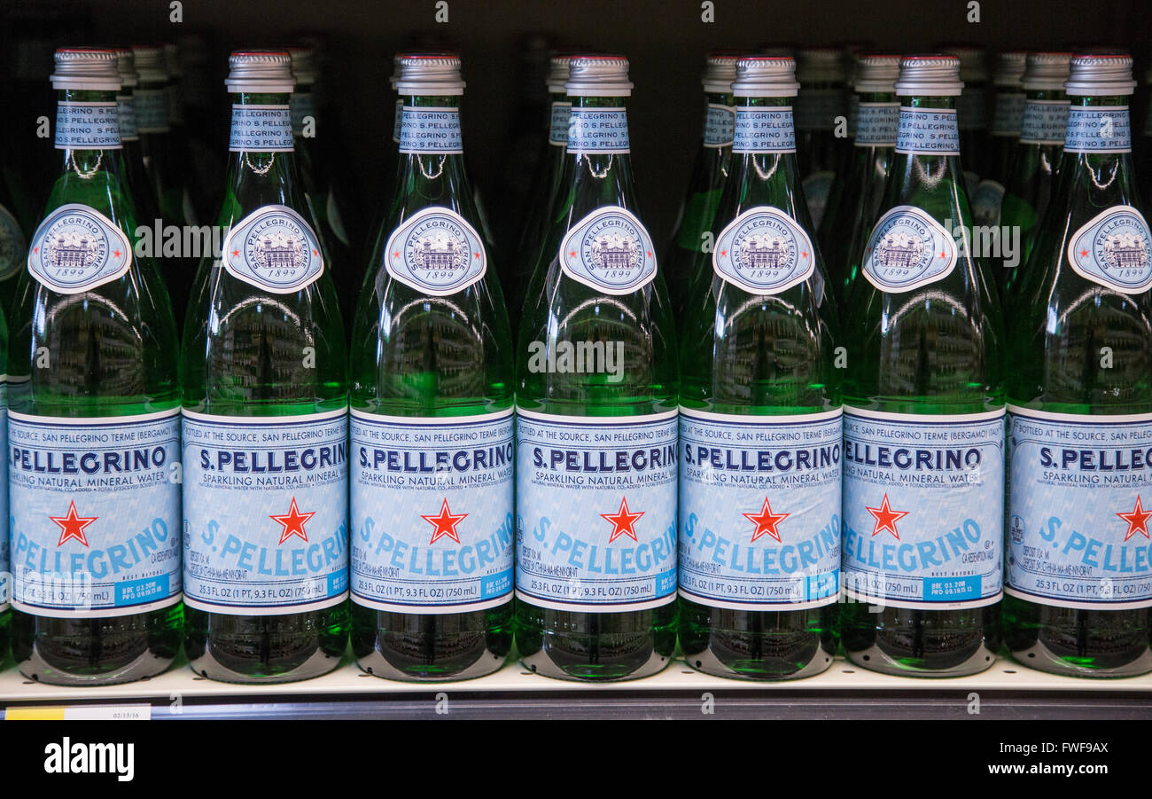 A row of San Pellegrino bottles on a grocery store shelf. Stock Photo