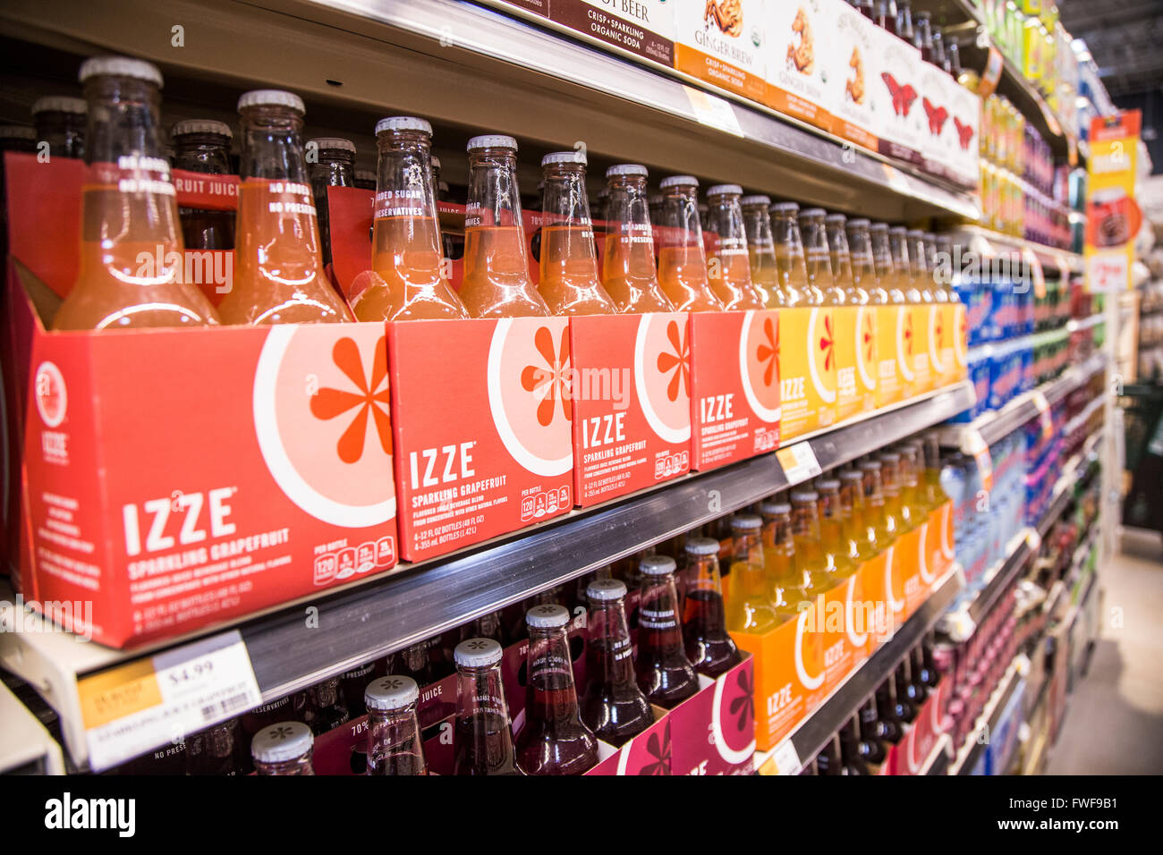 Packages of Izze brand organic sparking water beverage bottles on a grocery store shelf. Stock Photo