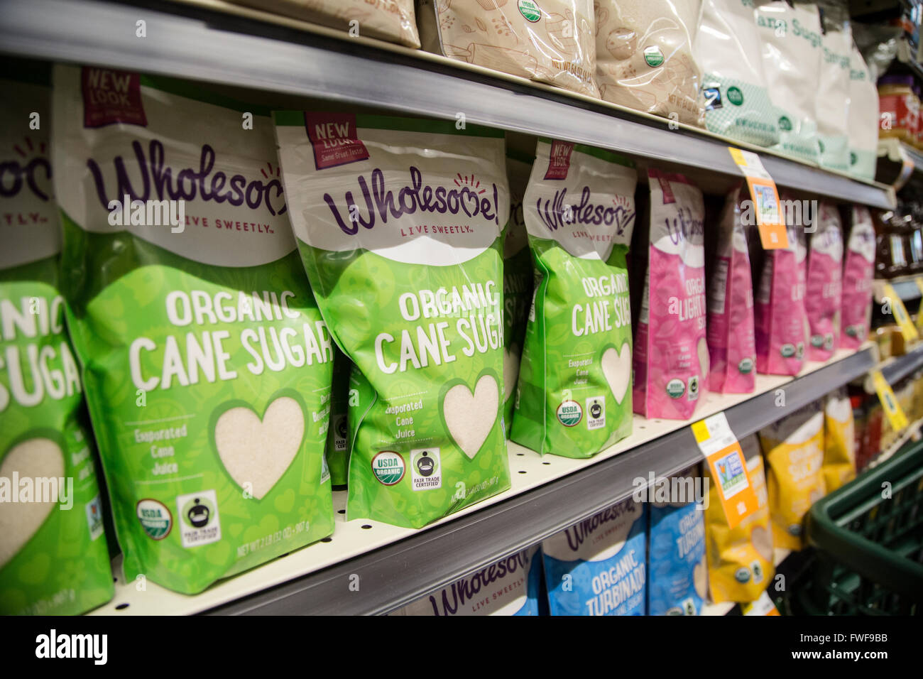 bags of organic cane sugar on a shelf at a grocery store Stock Photo