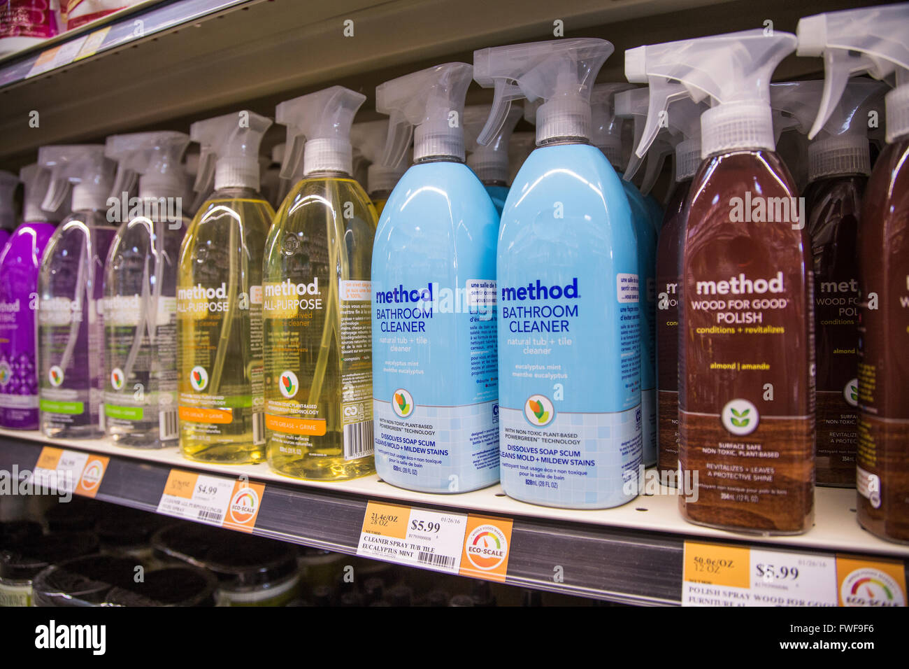 a display of Method cleaning spray bottles on the shelf of a grocery