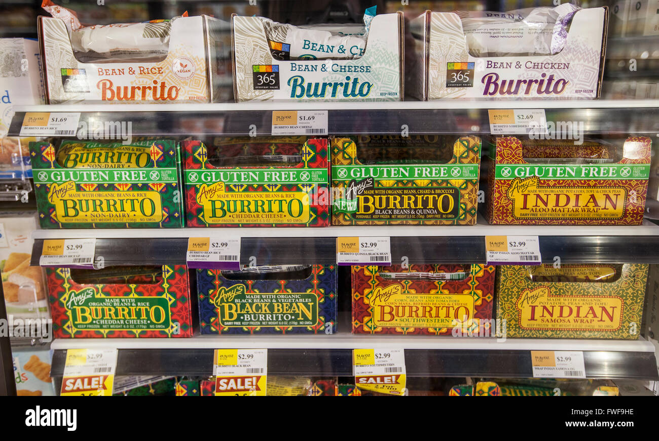 Frozen burritos displayed on shelves in the frozen case at a natural foods store Stock Photo
