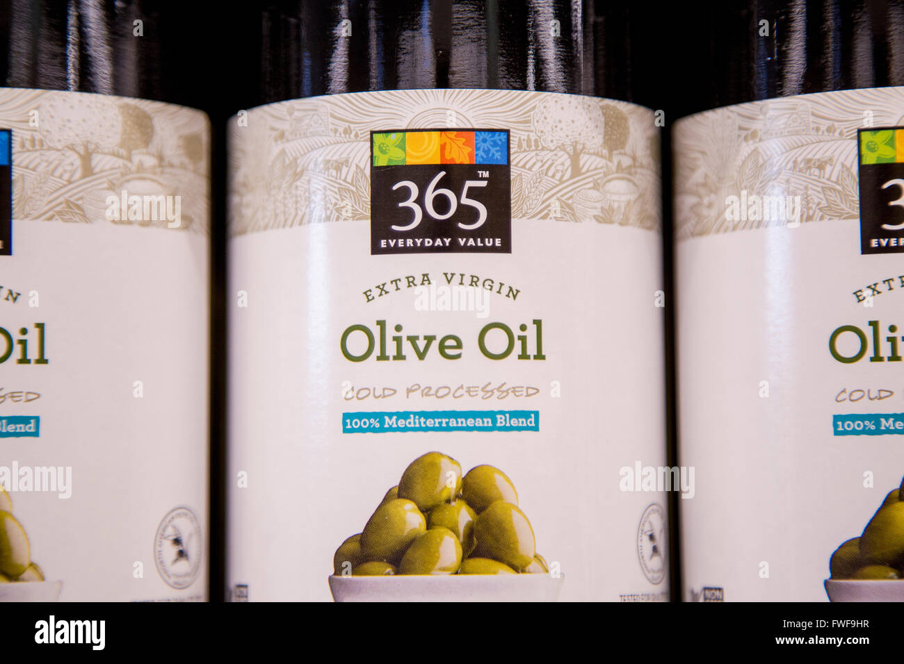 Bottles of olive oil sitting on a shelf at a grocery store Stock Photo