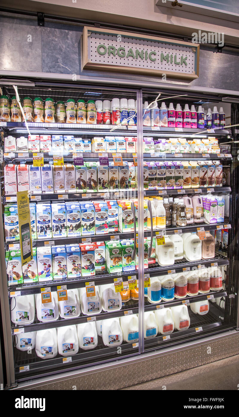 Organic milk displayed in a dairy case at a grocery store Stock Photo