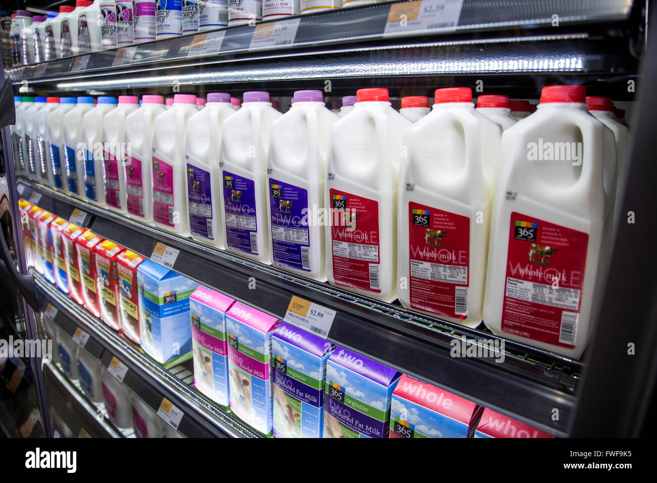 Organic milk displayed in a dairy case at a grocery store Stock Photo