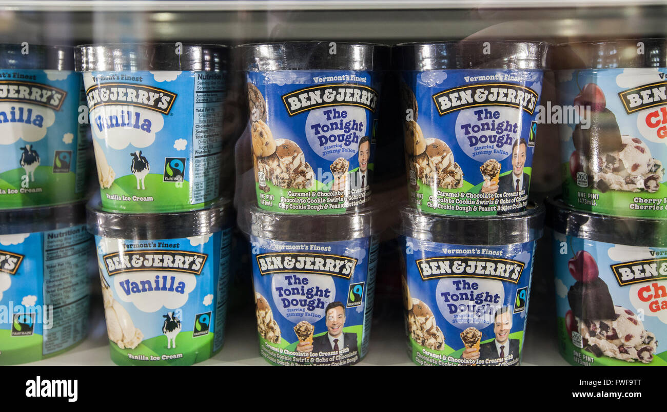 Ben & Jerry's brand pints of ice cream, stacked in the frozen foods case at a grocery store. Stock Photo