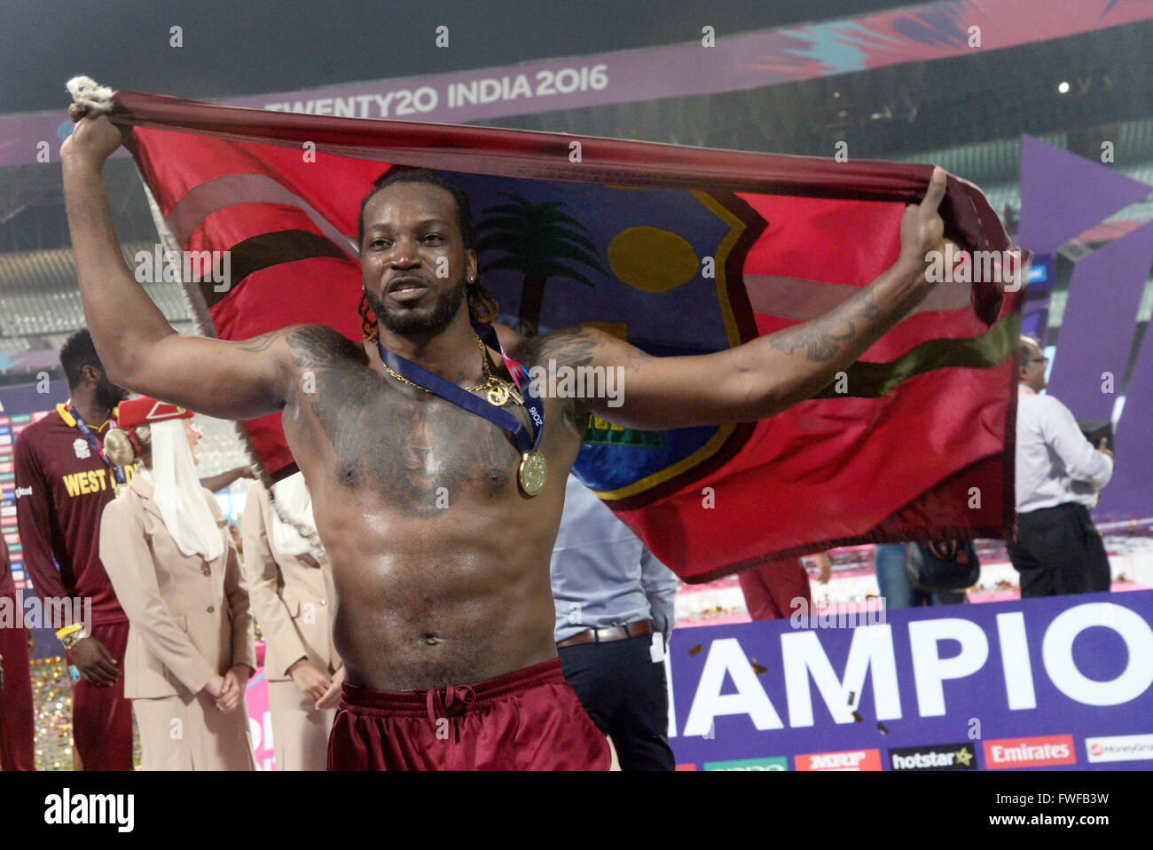 Chris Gayle celebrates West Indies World T20 final win with West Indies flag during ICC World T20 final match. West Indies beat England by four wickets in ICC T20 final at Eden Gardens, Kolkata. England batted first and scored 155 for 9 wickets by the help of Roots half century. Chasing the target West Indies win the game two delivers to left and four wickets in hand. Samuel score magnificent 85 and Brathwaite scored not out 34. Samuel grabs the player of the match award and India's Virat Kohli get player of player of the tournaments. (Photo by Saikat Paul/Pacific Press) Stock Photo
