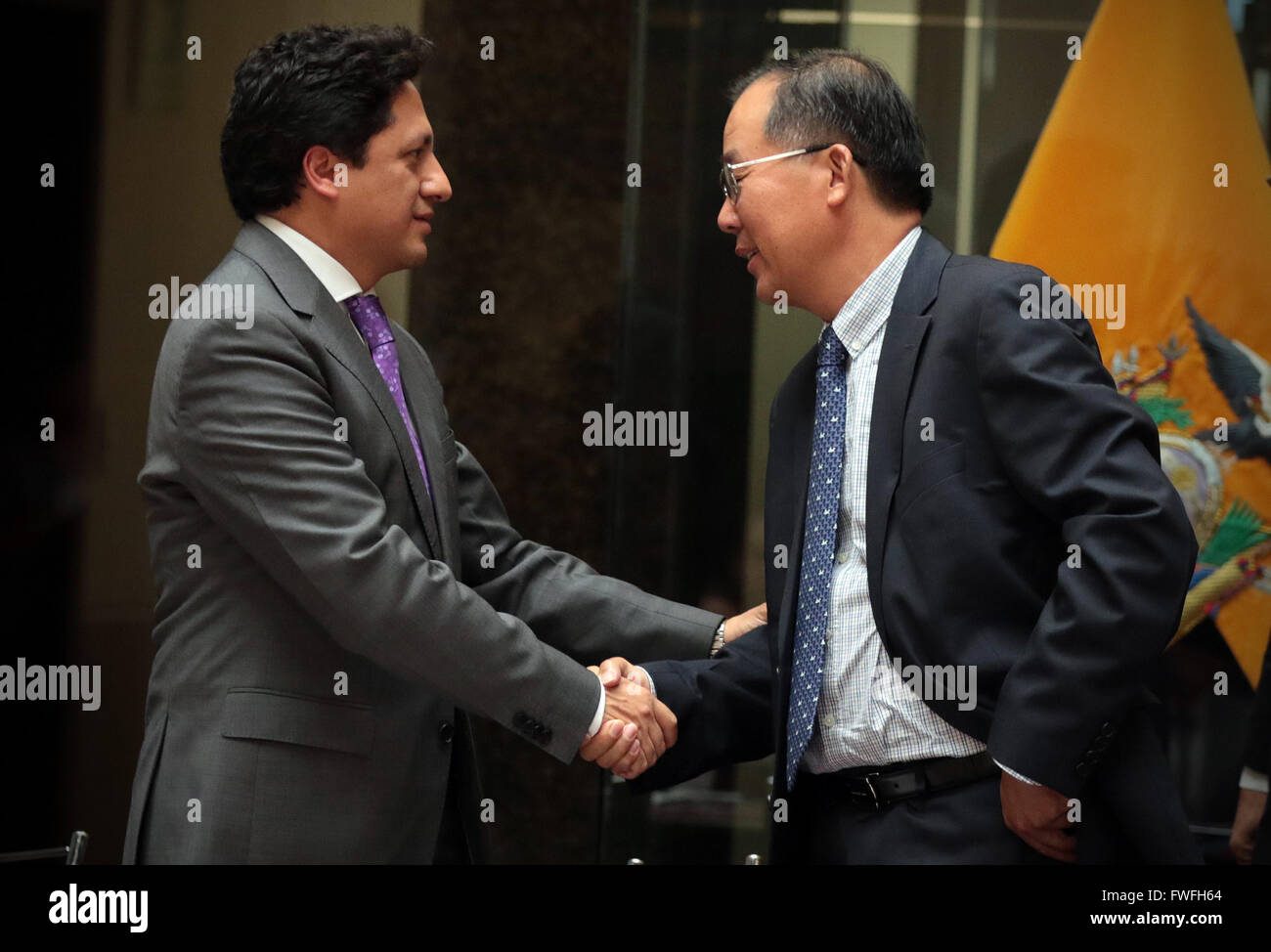 (160405) -- QUITO, April 5, 2016 (Xinhua) -- Chen Weilong (R), representative of China's Sinopec International and a member of Penaturi Consortium, shakes hands with Rafael Poveda, coordinating minister of strategic sectors of Ecuador, after the signing of a service contract in the Protocolar Hall of Ecuador's Vicepresidency, in Quito, capital of Ecuador, on April 4, 2016. Ecuador's government-owned Petroamazonas signed nine service contracts on Monday with international consortiums in efforts to develop its mature oil fields. Panaturi Consortium, made up of China's Sinopec International and S Stock Photo