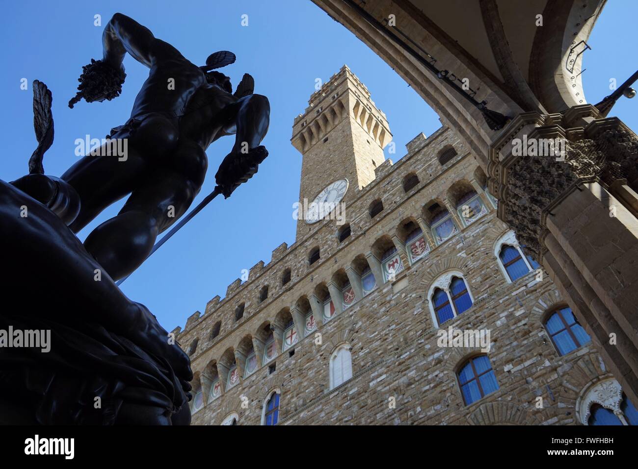 Italy: Palazzo Vecchio (town hall) with Perseus statue, seen from Loggia dei Lanzi in Florence. Photo from 20. February 2016. Stock Photo