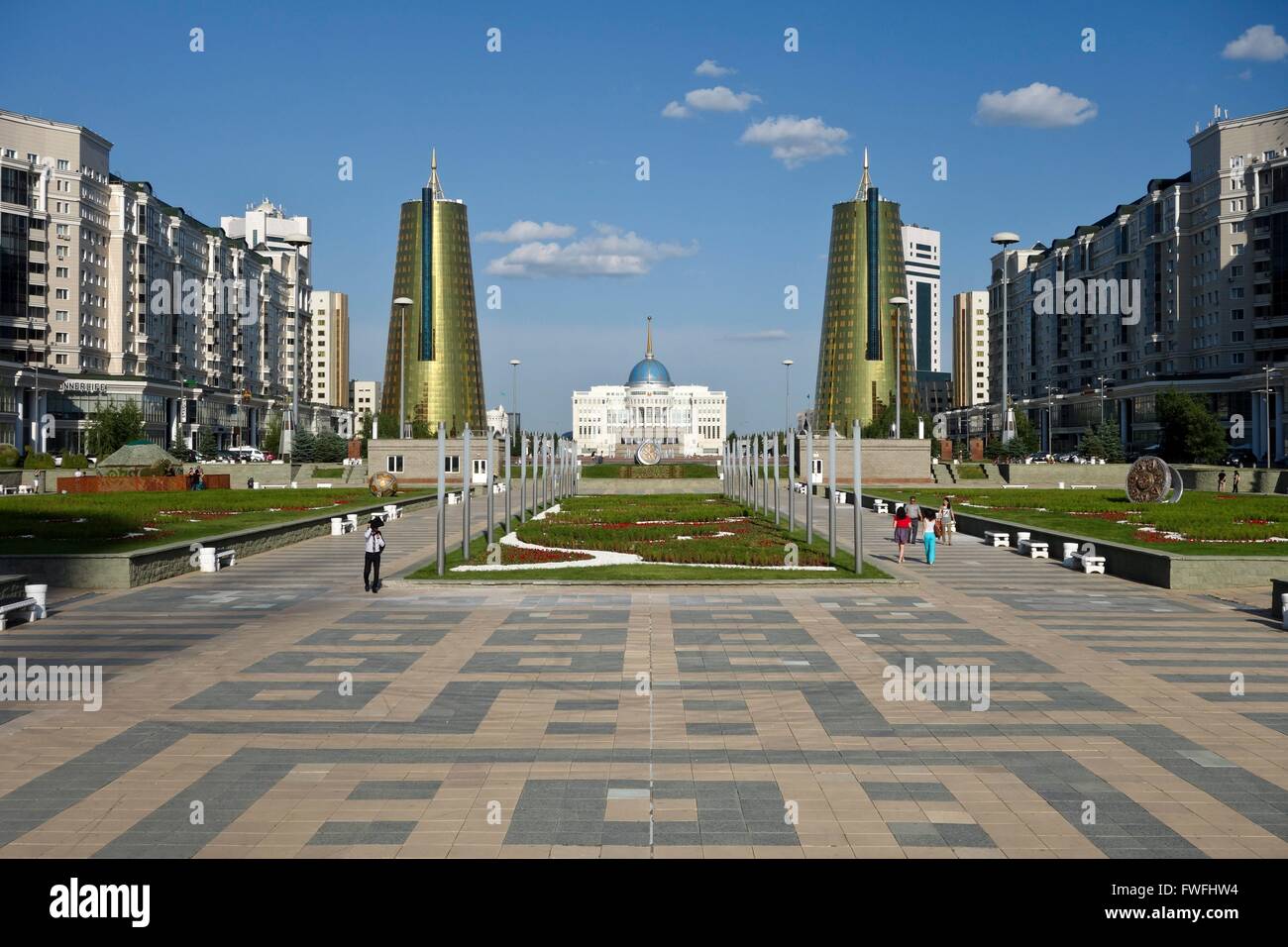 View along Nurzhol Bulvar to the presidential palace Ak Orda in Kazakhstan's young capital Astana. On the right and left side conical office buildings covered with golden-green glass. Picture taken 2013-06-21. Stock Photo