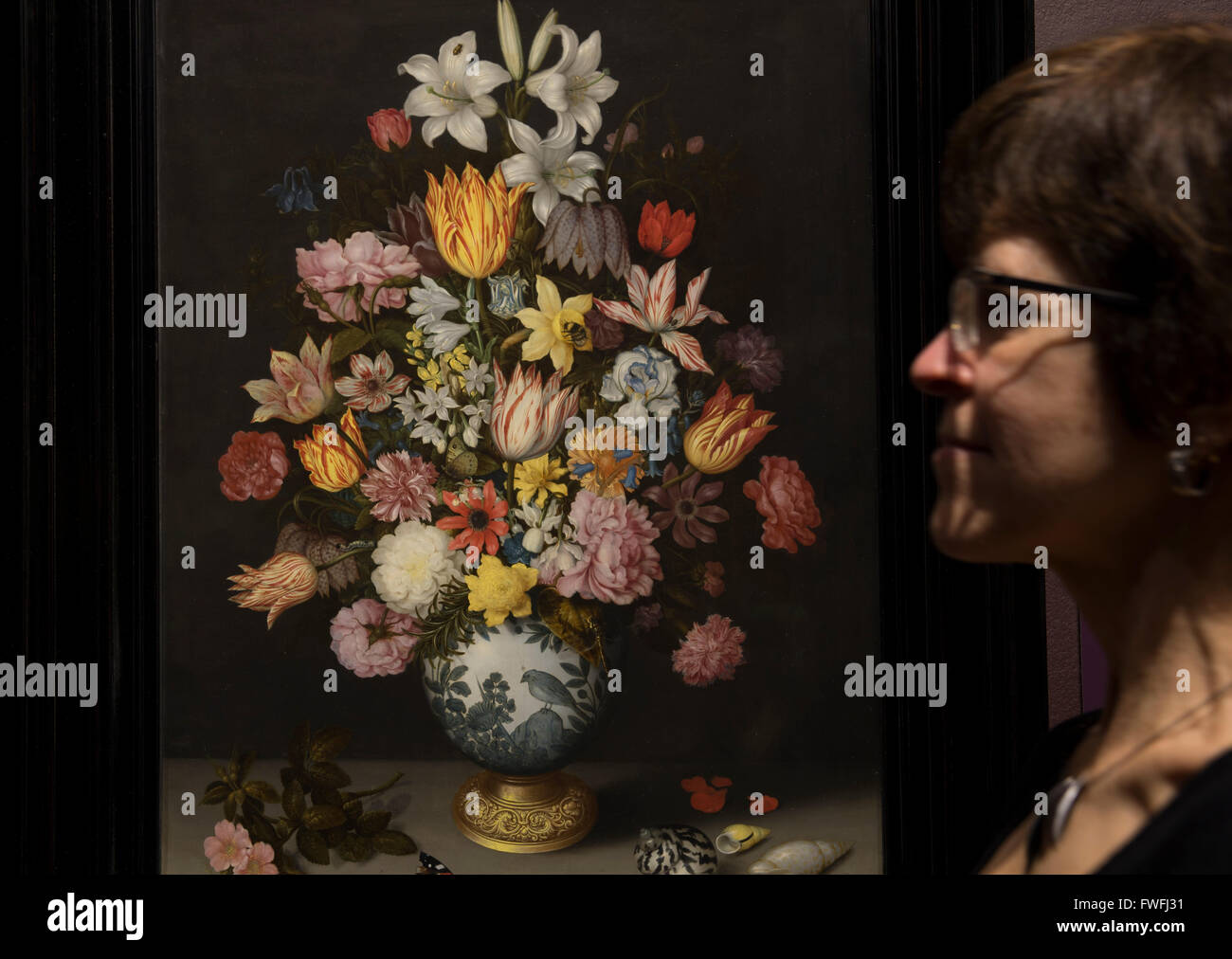National Gallery, London, UK. 5th April, 2016. Betsy Wiseman, Curator of Dutch and Flemish Paintings, examines A Still Life of Flowers in a Wan-Li Vase on a Ledge by Ambrosius Bosschaert the Elder. Coinciding with the Chelsea Flower Show, this exhibition explores Dutch flower painting from the 17th to the late 18th century. Credit:  artsimages/Alamy Live News Stock Photo