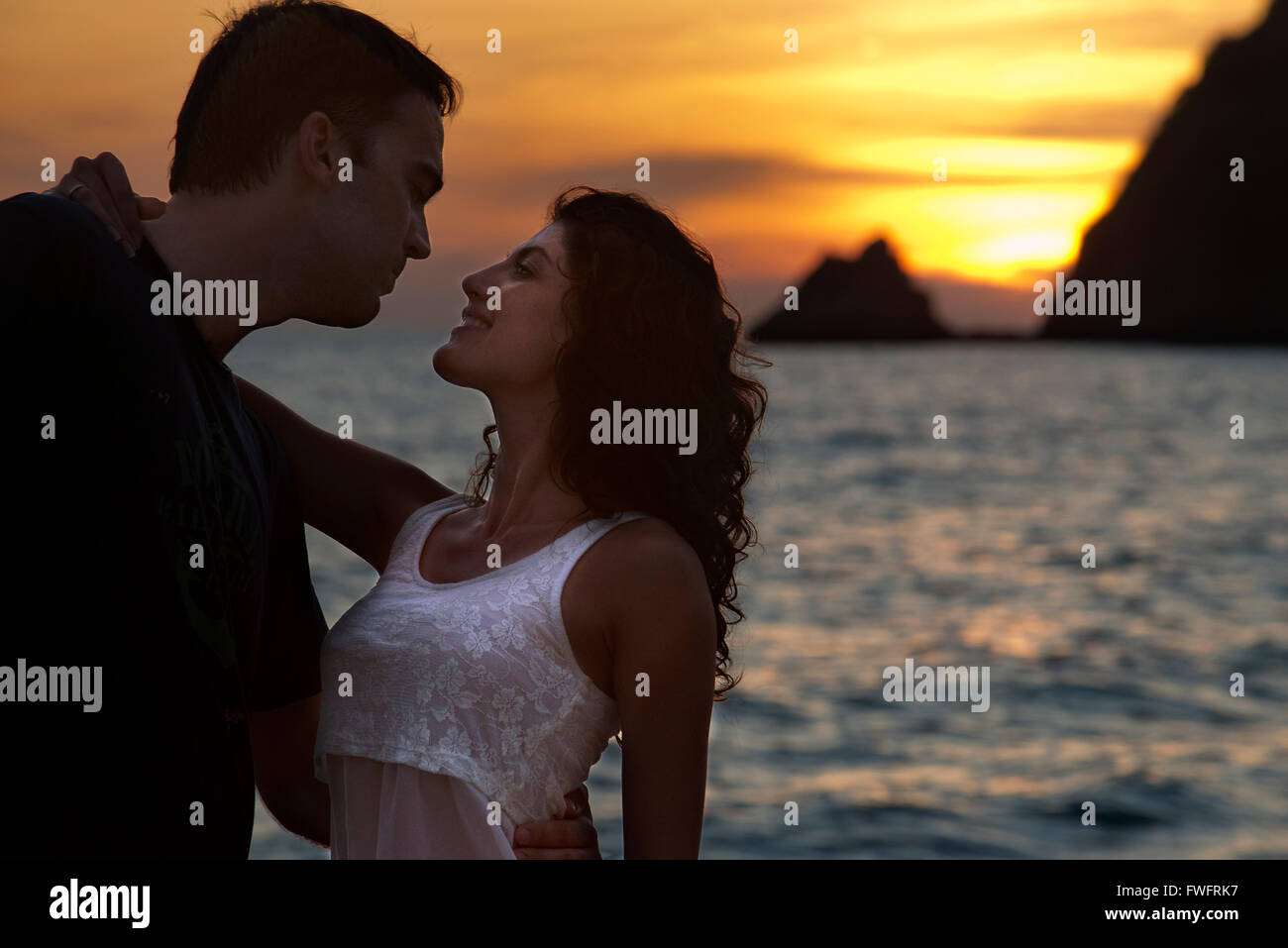 Couple lovers kissing at sunset in the beach. Kantiang Bay. Koh Lanta. Thailand. Asia. Kantiang Bay is most famous as the locati Stock Photo