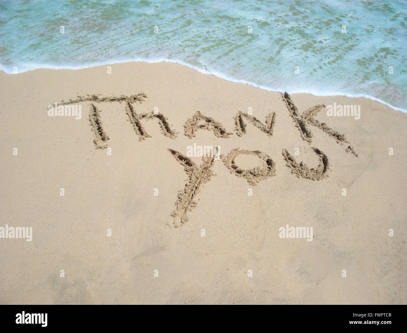 Thank you written in the sand Stock Photo - Alamy