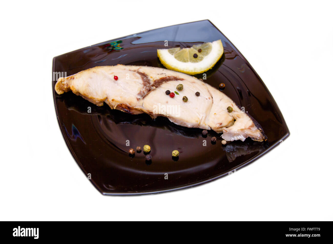 Swordfish slice on the plate on white background Stock Photo