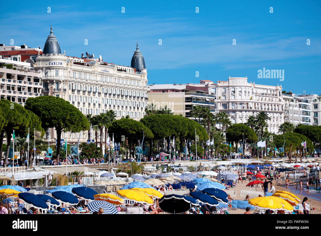 View of the busy crowded beach and croisette boulevard in Cannes, Cote d'Azur, France Stock Photo