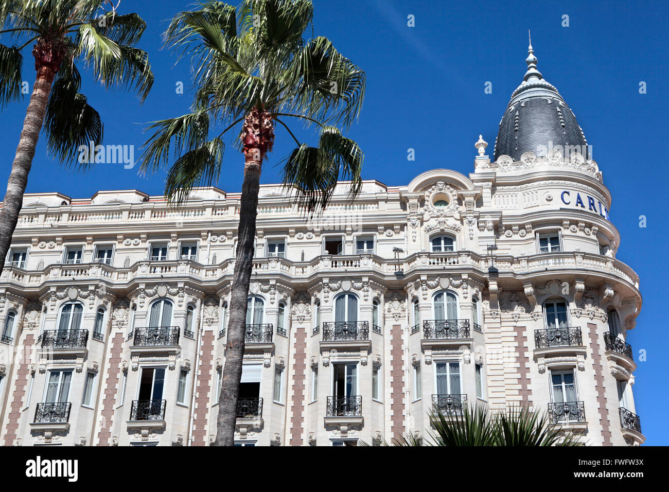 Front and corner view of the facade and dome of the famous Carlton International Hotel in Cannes Stock Photo