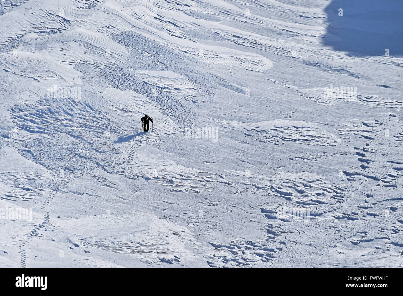 Mountaineer climbing with crampons on alpine valley in Fagaras Mountains in Romania Stock Photo