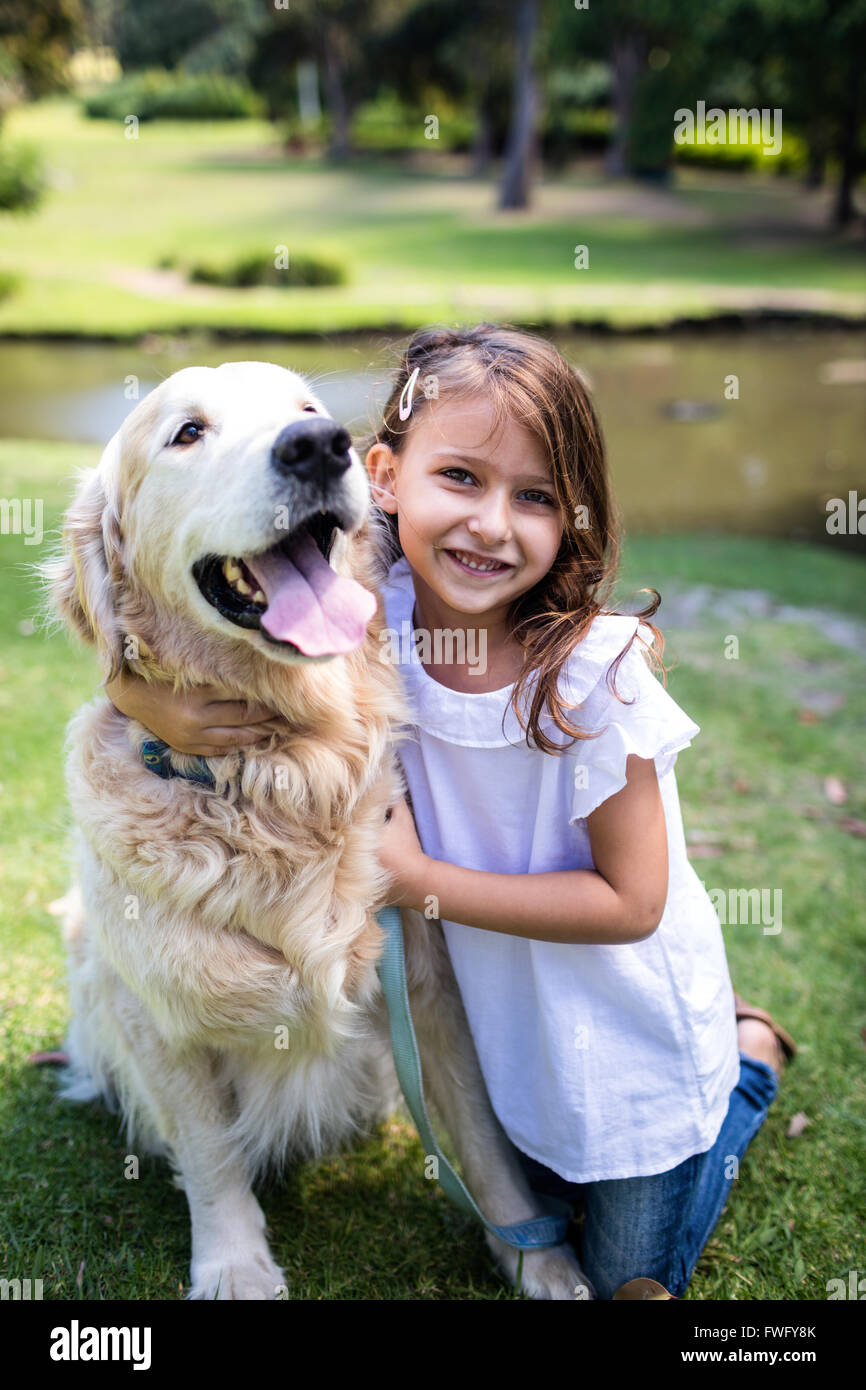 Smiling girl with her pet dog in the park Stock Photo - Alamy