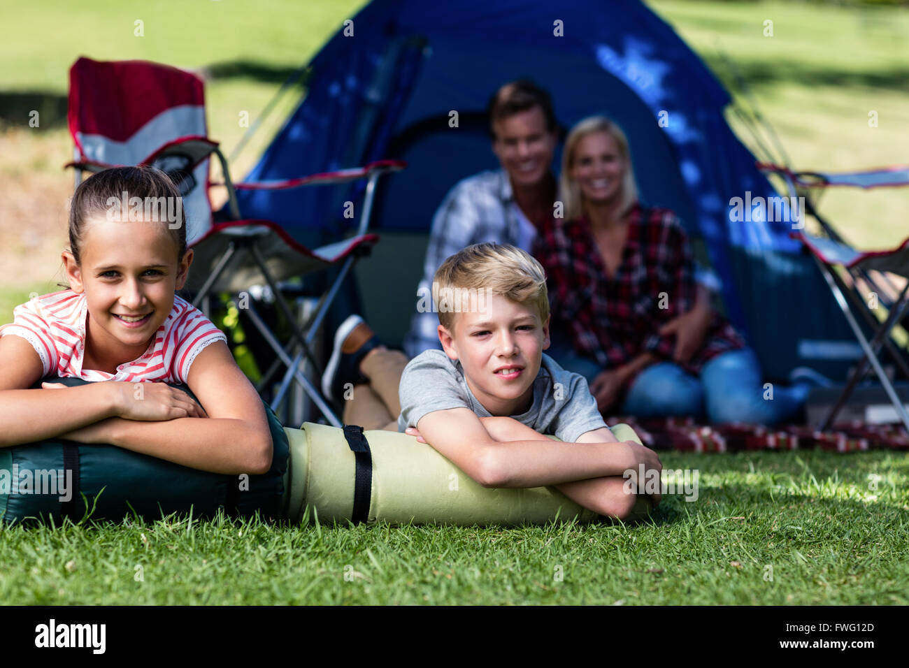 Smiling siblings lying outside hi-res stock photography and images - Alamy