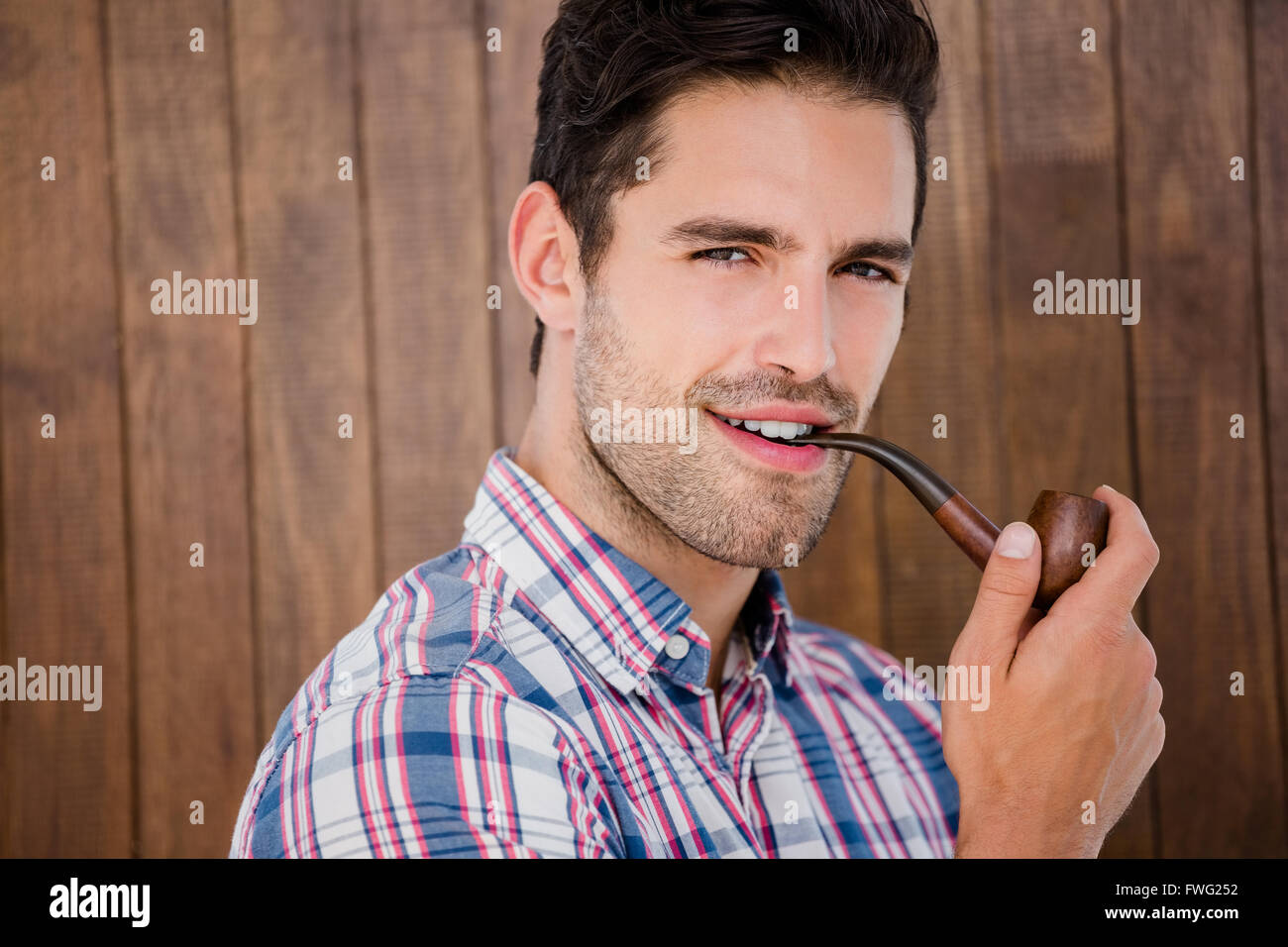 Young man smoking pipe Stock Photo