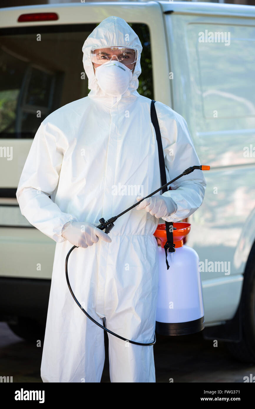 Pest control man standing behind a van Stock Photo Alamy