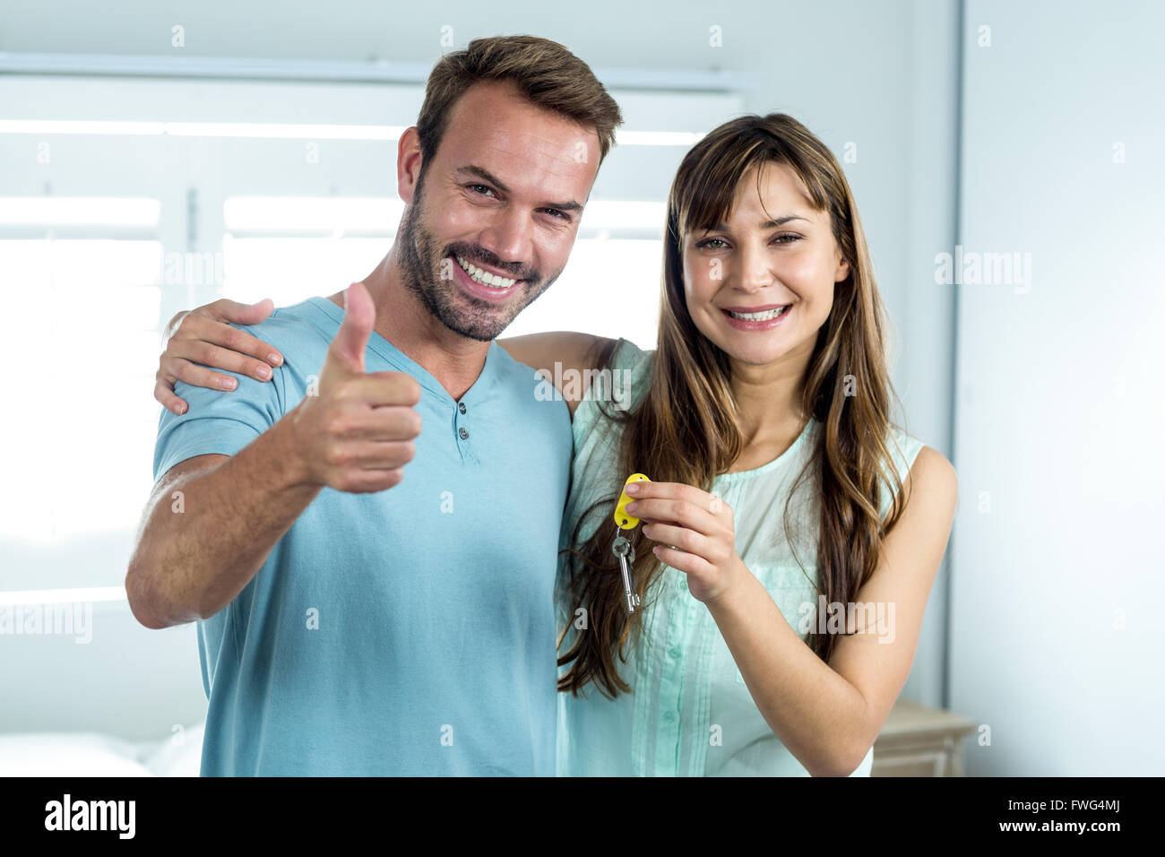 Smiling couple with key at new house Stock Photo - Alamy