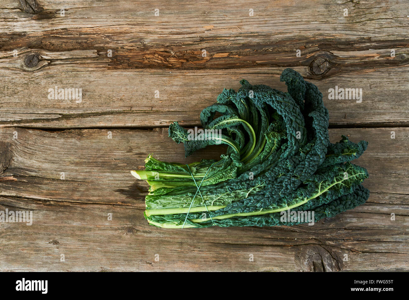 A delicious vegetables, the Kale or leaf cabbage on an old wooden table Stock Photo