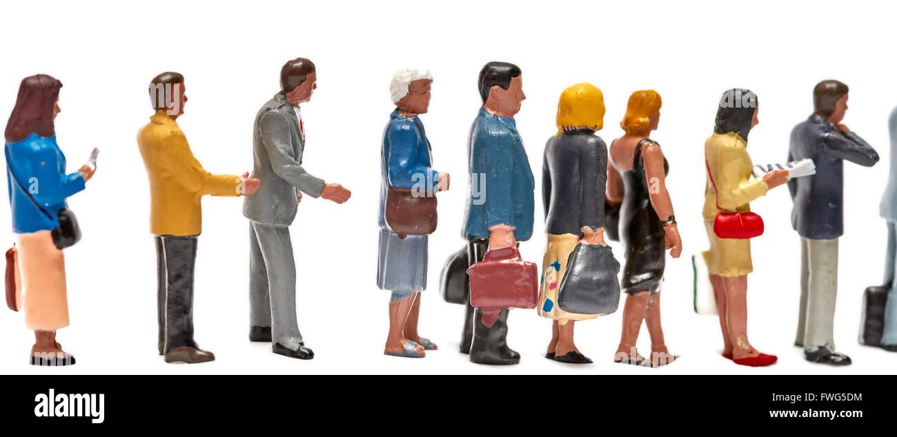 Miniature figure people forming an orderly queue against a white background Stock Photo