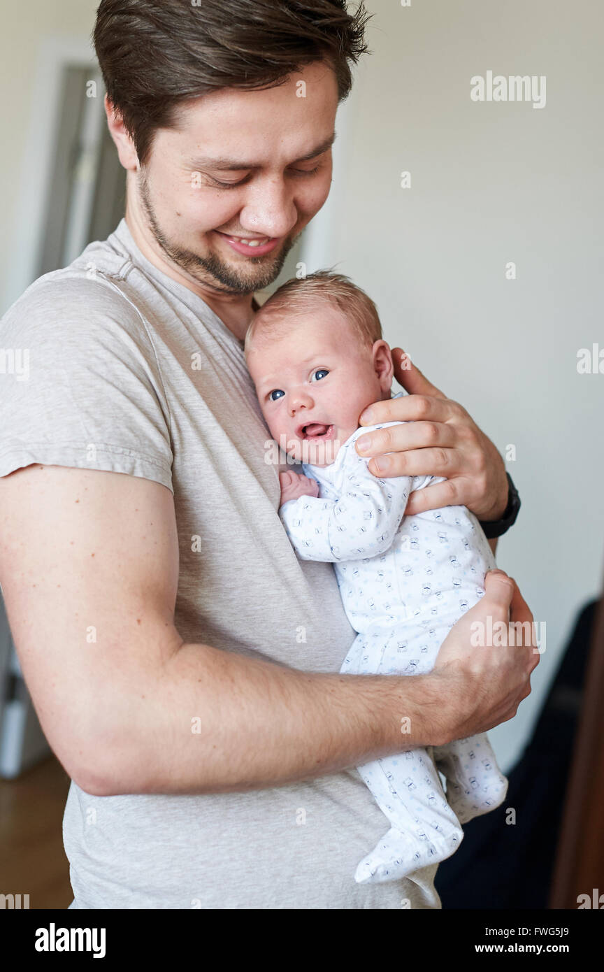 Happy father holding newborn baby in his arms Stock Photo