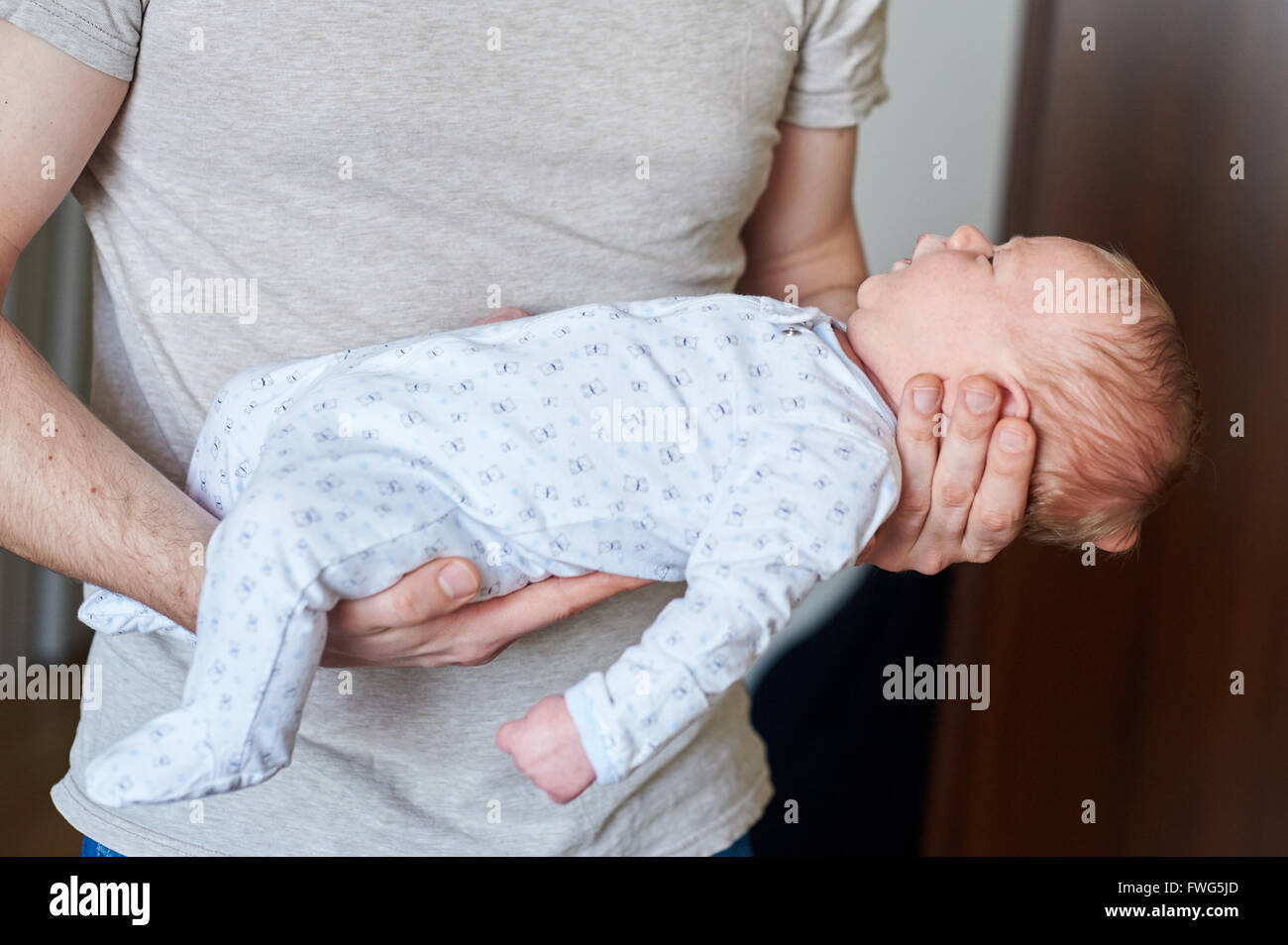 Happy father holding newborn baby in his arms Stock Photo
