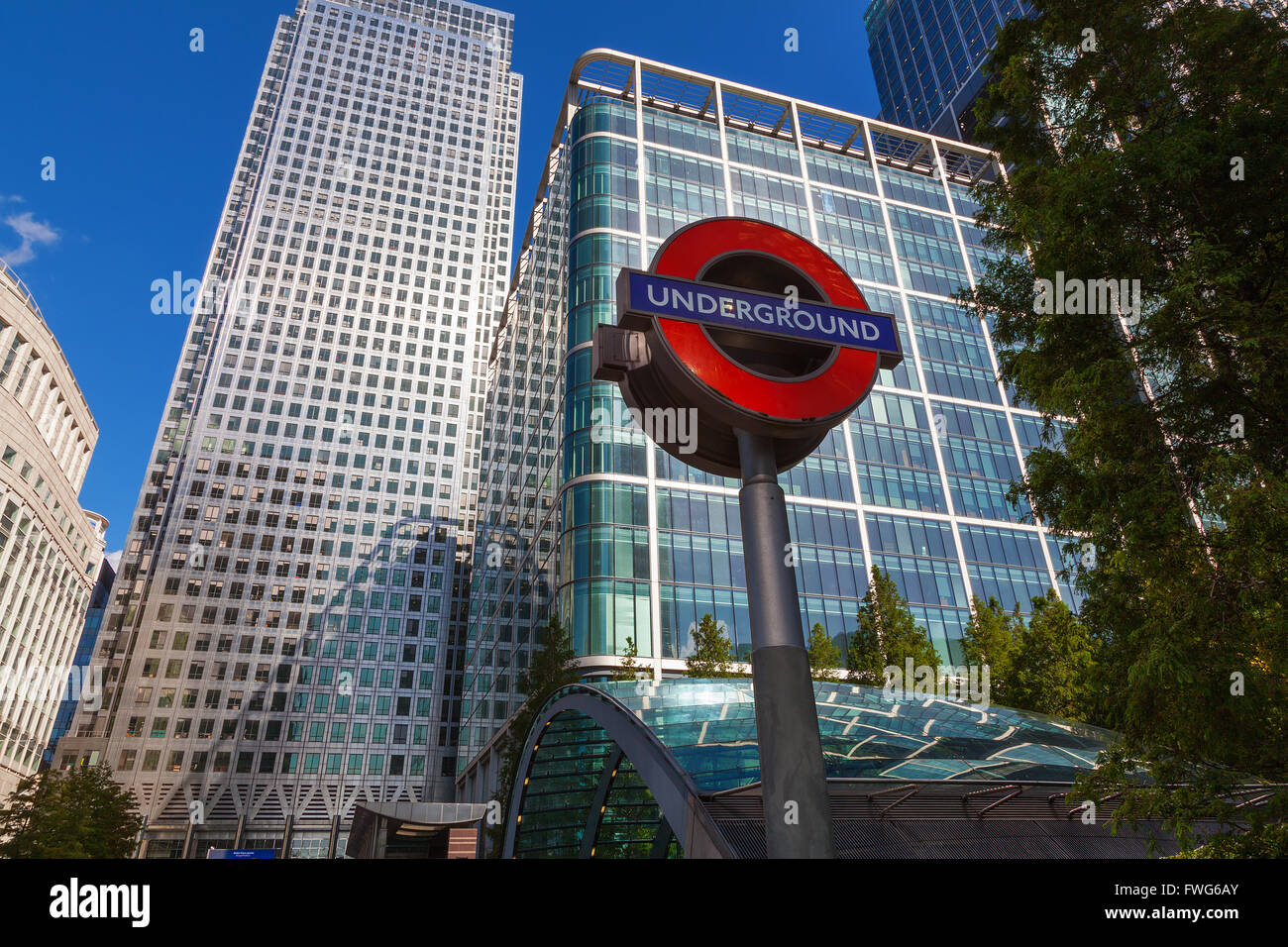 Skyscrapers and London Underground sign at Canary Wharf, Docklands the heart of the financial district of London Stock Photo