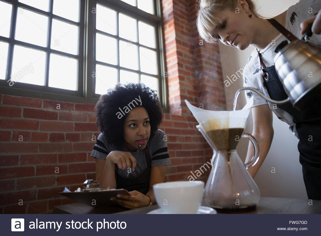 Baristas monitoring pour over coffee making Stock Photo